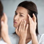 Woman checking Face in Mirror