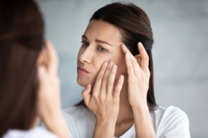 Woman checking Face in Mirror