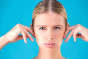 Woman touching her ears